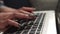 Woman's hands pressing keys on laptop keyboard