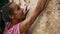 Woman`s hands reaching and holding rock holds on a yellow cliff