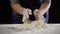 Woman`s hands shake off the dough at kneading