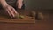 Woman`s hands slicing kiwi, slow motion.