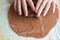 Woman`s hands squeeze christmas shapes gingerbread cookie from the dough.