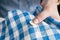 Woman`s hands stitching button on a shirt in tailor shop