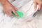 Woman`s hands washing white color clothes in the basin