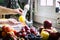 Woman`s hands washing a yellow apple under the water flush, assortment of fresh fruit in kitchen