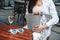 Woman`s hands which holding knitted bag sitting at the table of a street cafe. Copy, empty space for text