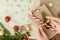 Woman s hands wrapping Christmas gift, close up. Unprepared christmas presents on wooden background with decor elements and items