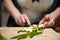 Woman`s hands with zucchini-cut ring on the kitchen cutting board