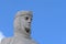 Woman`s head. White marble monument with a crown