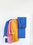 Woman\\\'s jacket, pants and linen shirts in bright colours with space for text.