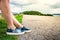 Woman\'s leg sitting on highway guardrail at the roadside