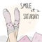 Woman`s legs in cozy socks and hand lettering Smile It`s Saturday.