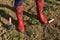 Woman`s Legs in Red Boots on a Soil