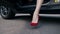 Woman`s legs in red high heels stepping out of car