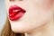 Woman\'s lips biting a red jelly