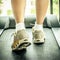 Woman\'s muscular legs on treadmill