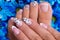 Woman's nails of hands and legs with french manicure