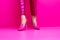 A woman\\\'s pink shoes are shown in a photo