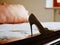 Woman`s shoe on the bed