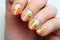 Woman\\\'s short fingernails with seasonal Easter nail art design with carrots