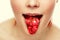 Woman\'s tongue. Woman with open mouth and cherry toungue.