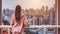 A Woman\\\'s Tranquil Moment with a City View from the balcony Generative AI