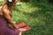 Woman with Sadhu board with nails on grass lawn outdoors