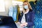 woman with safety mask using laptop in public transport. covid-19 pandemic