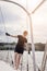 Woman on sailboat with boat hook preparing to dock boat