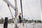 Woman on sailboat with boat hook preparing to dock boat