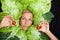 Woman with salal leafes around her head.