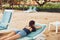 woman sand beach sea ocean lifestyle smiling young resort sunbed lying
