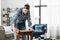 woman sanding old round wooden table with sponge