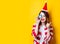 Woman in Santa Claus hat with little alarm clock