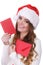 Woman in santa claus hat reading letter