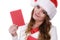 Woman in santa claus hat reading letter