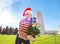 Woman in Santa hat with Christmas tree near Leaning Tour, Pisa