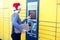 Woman with santa hat client using automated self service post te