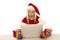 Woman in santa hat and colored socks with laptop shocked