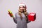Woman in Santa hat open Christmas gift