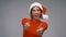 Woman in santa hat showing thumbs up on christmas