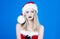 Woman in santa hat with Winter makeup. New year celebrating. Christmas girl. Beautiful woman in Santa Claus clothes.