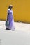 Woman in saree walking on street in Pondicherry, India.