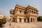 Woman in sari walking past fantastic building in India