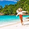 Woman with sarong on beach at Seychelles