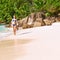 Woman with sarong on beach at Seychelles