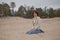 Woman sat on beach in rain