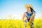 Woman with saxophone in rapeseed field