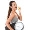 Woman, scale and smile with apple in studio on white background for body weight, progress and fat loss with fitness