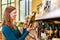 Woman scanning bottle olive oil in supermarket