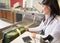 Woman Scanning Tag On Luggage At Airport Check-in